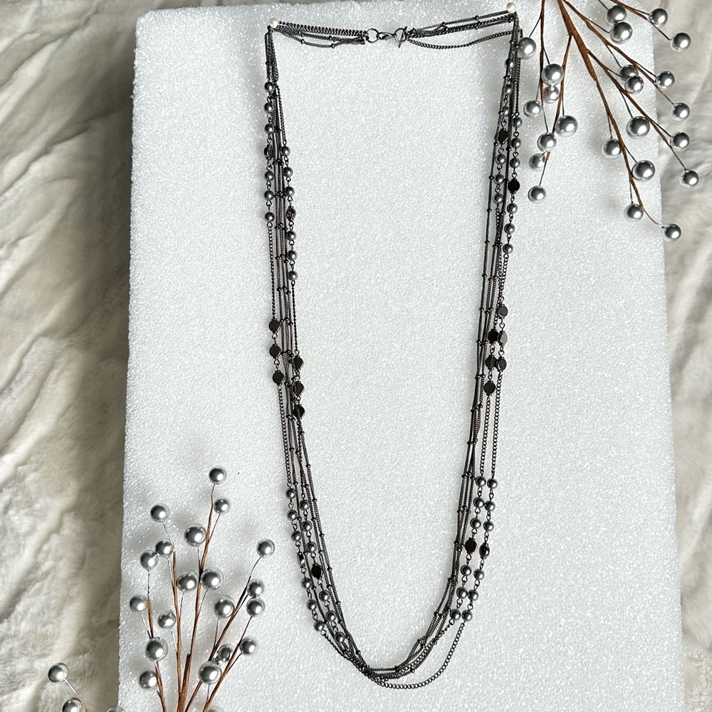 Long multi-strand necklace in dark metal tone with hematite looking beads